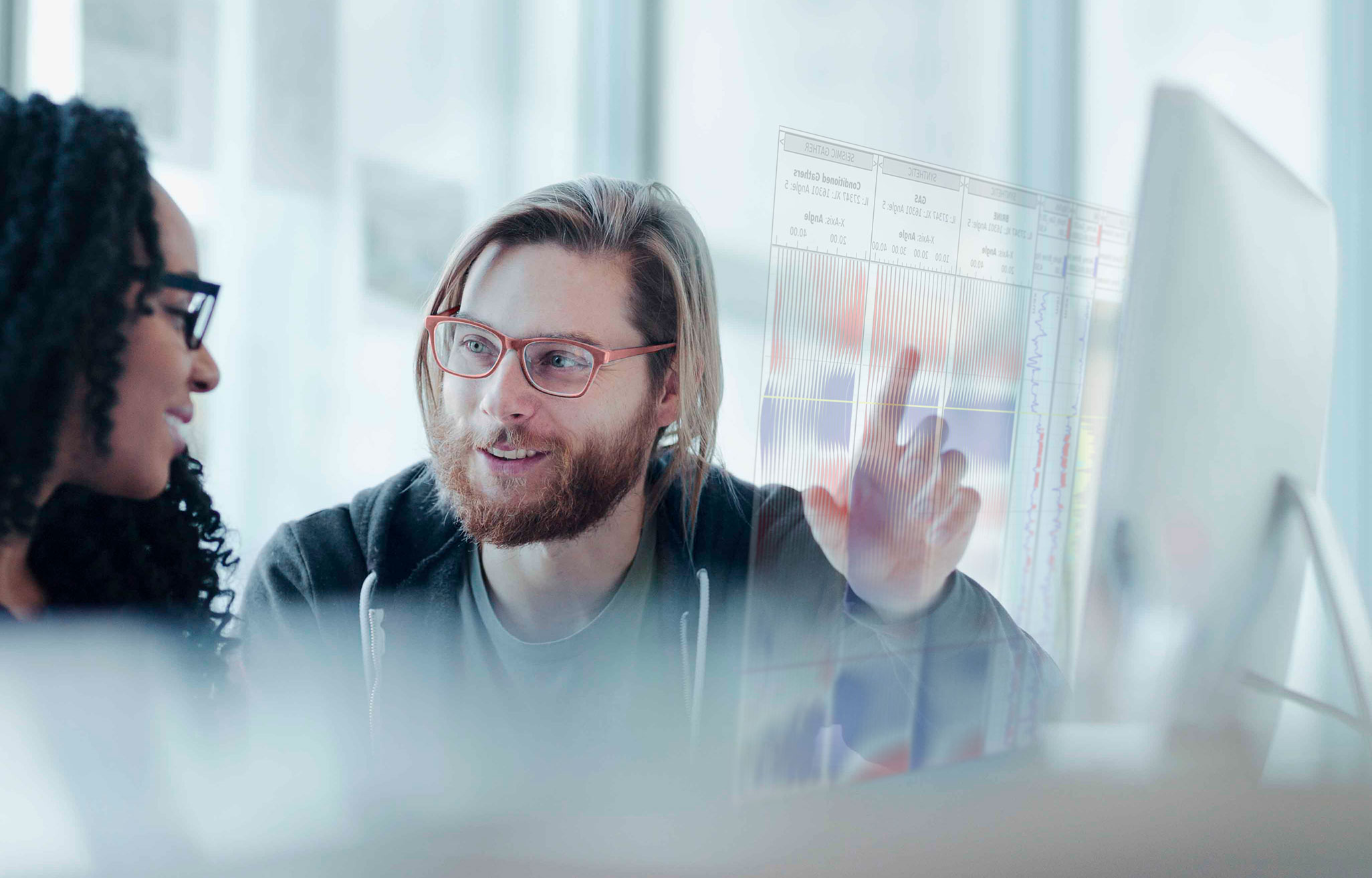 Consultants analyzing seismic data in advanced visualization software – Sharp Reflections