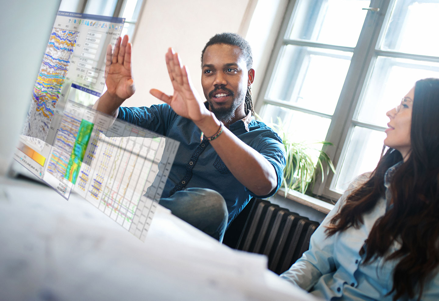Geophysicist working on seismic data at desktop workstation – Sharp Reflections